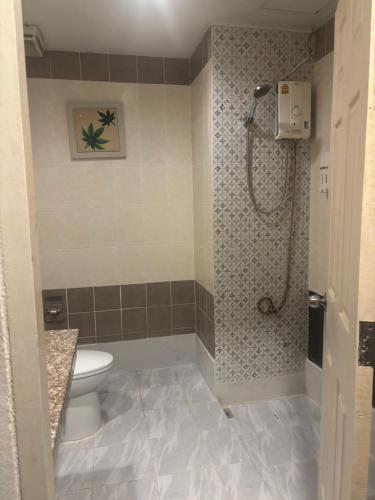 a bathroom with a toilet and a shower in it at Aonang Cozy VIP in Ao Nang 