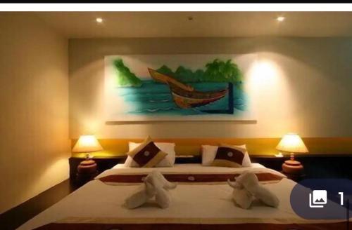 a bedroom with a bed with a painting on the wall at Aonang Cozy VIP in Ao Nang 