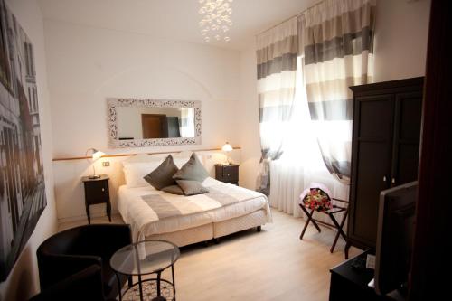 a hotel room with a bed and a window at Hotel Mini Palace - Country House in Molinella