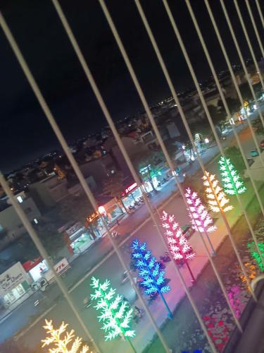a view of a street at night with christmas lights at GÂY THƯƠNG NHỚ Homestay Phòng trong vinhome grand park tên cũ I love vinhome grand park in Gò Công