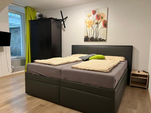 a bedroom with a bed with a black headboard at Brilliant Souterrain Apt - Prter Amuesement Park in Vienna