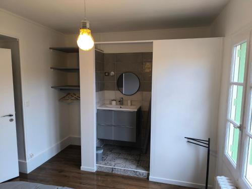 a bathroom with a sink and a mirror at Chez Marine & Justine in Charolles