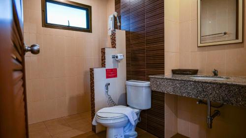 a bathroom with a toilet and a sink at Kata Silver Sand in Kata Beach
