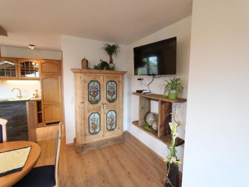a kitchen with a wooden cabinet with stained glass windows at Holiday home in Taxenbach in Taxenbach