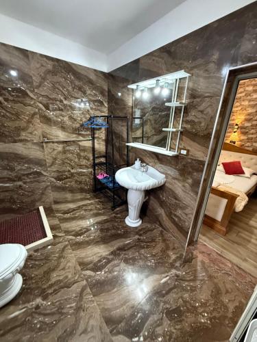 a bathroom with a sink and a mirror at villa Heljos apartaments in Vlorë