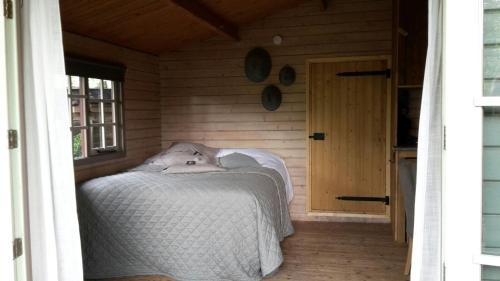 a bedroom with a bed with a dog laying on it at Vrijzicht in Ochten