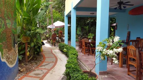 a patio of a restaurant with tables and plants at La Posada Jungle Hotel in Manuel Antonio