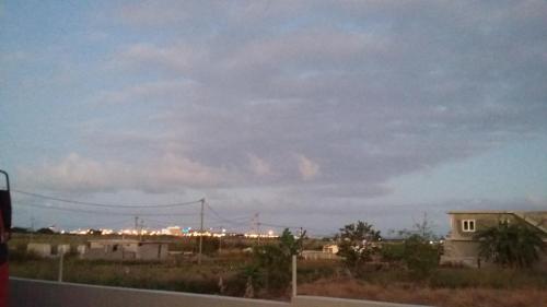 a view of a city with a cloudy sky at Kaz Resident in Plaine Magnien