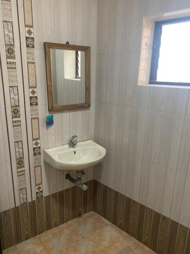 a bathroom with a sink and a mirror at Hotel Beach Avenue in Calangute