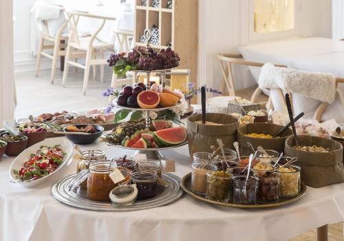 a table with many plates of food on it at Stammershalle Badehotel in Bådsted