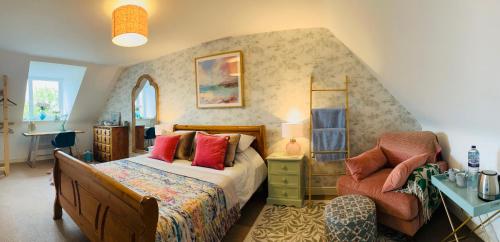 a bedroom with a bed and a chair at Number 2, Spacious Rooms, Near Ironbridge! in Telford