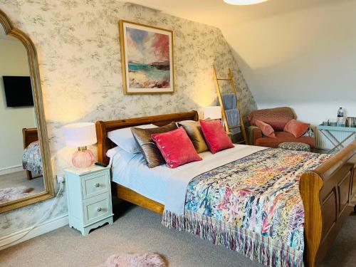 a bedroom with a bed with red pillows and a mirror at Number 2, Spacious Rooms, Near Ironbridge! in Telford