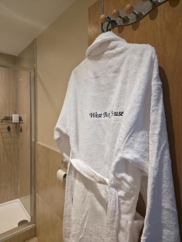 a white sweatshirt hanging on a rack in a bathroom at West Beck House Darlington - Penthouse Double En-Suite in Darlington
