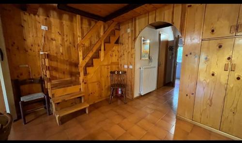 a hallway with wooden walls and stairs in a house at Agrifoglio in Torre Caprara