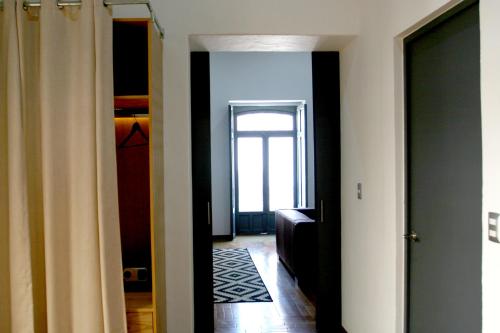 a hallway with a door leading to a room at Markee Hotel Boutique in Querétaro