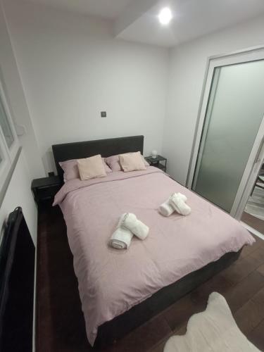 a bedroom with a bed with two towels on it at Apartman Ani in Vinkovci