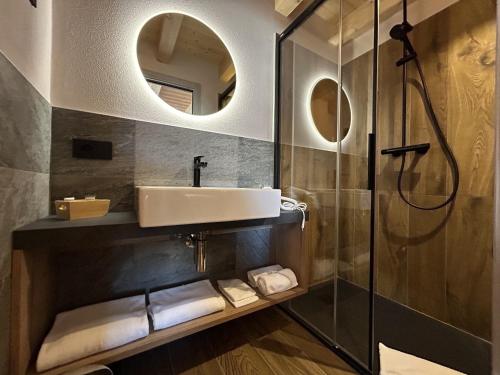 a bathroom with a sink and a shower at Livigno Chalets in Livigno