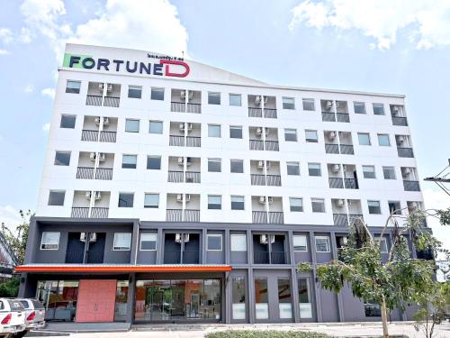 a white building with a ford sign on it at Fortune D Hotel Loei in Loei