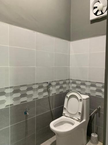 a bathroom with a toilet with the lid up at Homestay kampung moden in Pendang