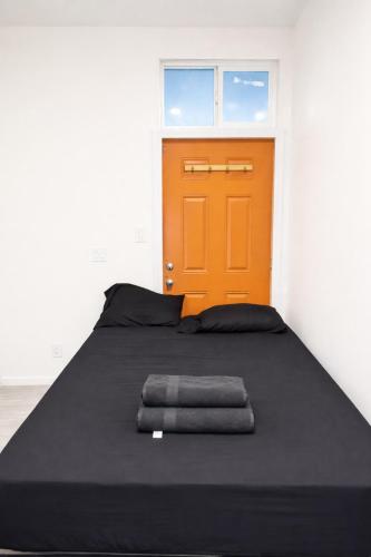 a bed in a room with an orange door at La Cienega Soul in Los Angeles