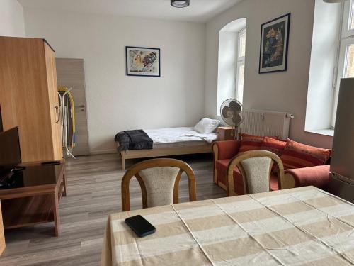 a living room with a bed and a couch at Appartement 3 in Diemelstadt 