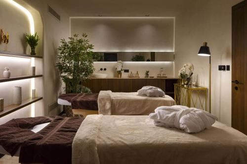 two beds sitting in a room with aocrinologistsocrinologists at Sea view Mercury Tower, Rooftop infinity Pool in St. Julianʼs