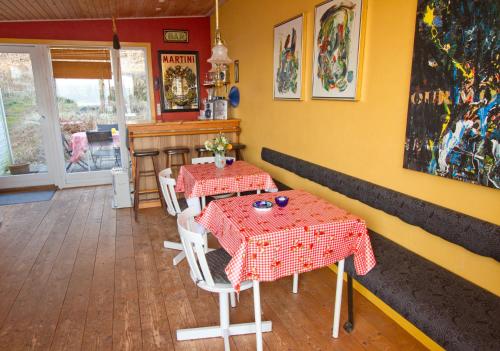 a dining room with two tables and a bar at Casa Mundo Bed & Breakfast in Vejle