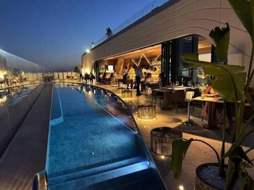 a swimming pool in a building with a restaurant at Sea view Mercury Tower, Rooftop infinity Pool in St. Julianʼs