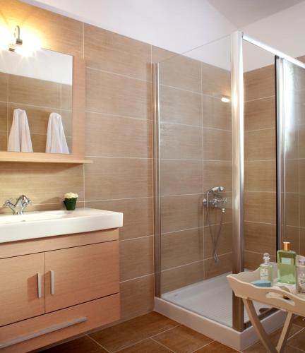 a bathroom with a shower and a sink at Villa Asteri in Vlachopoulátika
