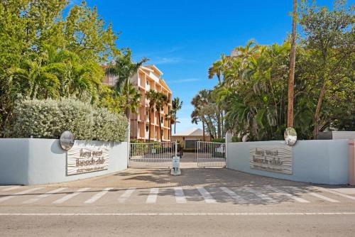 a fire hydrant in front of a building with trees at Beach Club Oasis #304 in Key West
