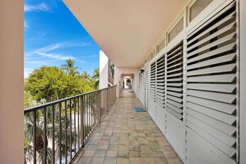a balcony of a house with a walkway at Beach Club Oasis #304 in Key West