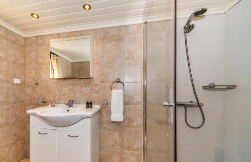 a bathroom with a sink and a shower at Amalthia Cottage in Vathi