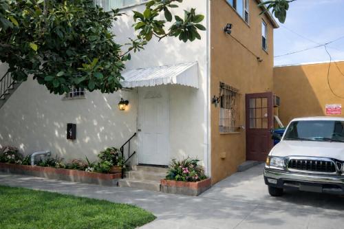 a white car parked in front of a house at La Cienega Soul in Los Angeles