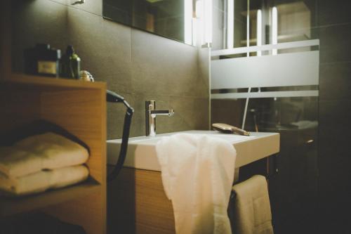 a bathroom with a sink with a towel on it at Arabella Retreat & Spa in Nauders