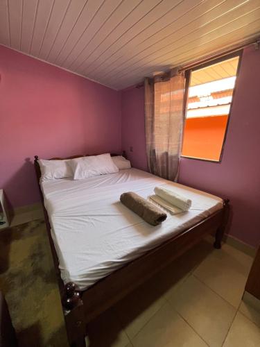 a small bedroom with a bed with a window at Twendzetu kilifi in Kilifi