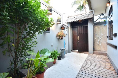 a hallway of a house with a door and plants at Holiday Haven Ukulhas in Ukulhas