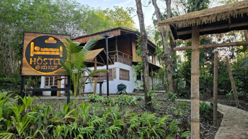 a building with a sign in front of it at Hostel Ko Kut in Ko Kood