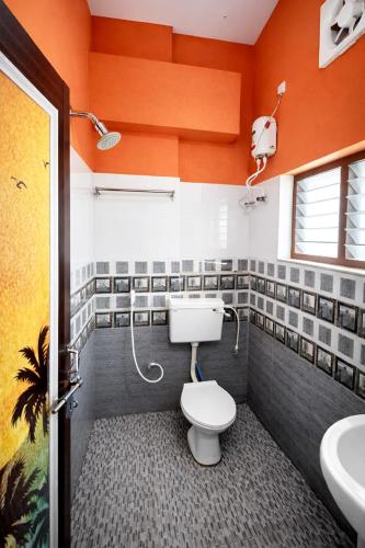 a bathroom with a toilet and a sink at Varkala Days Home Stay in Varkala