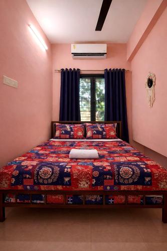 a bedroom with a bed and a window at Varkala Days Home Stay in Varkala