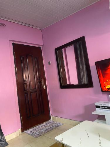 a room with a brown door and a mirror at Twendzetu kilifi in Kilifi