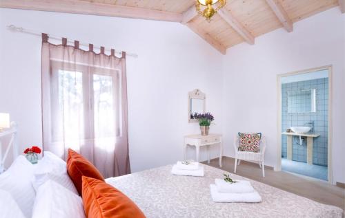 a bedroom with a bed with two towels on it at Olive Cottage in Petrátika