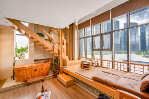 a large room with a bed and a bath tub at Phoenix Dragon M.I.C.E Hotel in Kunming