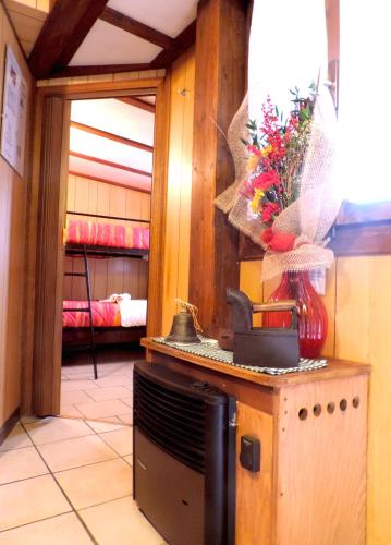 a kitchen with a stove with a vase of flowers at Villaggio Turistico Camping Cervino in Antey-Saint-André
