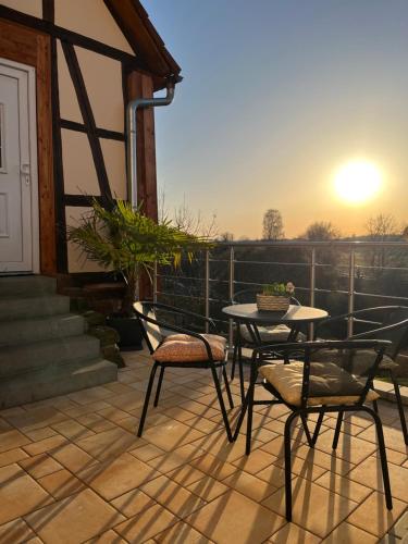 a patio with a table and chairs on a balcony at Ferienhaus Schwalmblick in Schwalmstadt