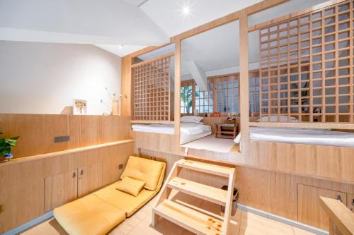 a room with a tub and a bed and a chair at Phoenix Dragon M.I.C.E Hotel in Kunming