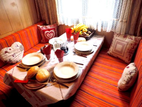 a table with plates of food on top at Villaggio Turistico Camping Cervino in Antey-Saint-André