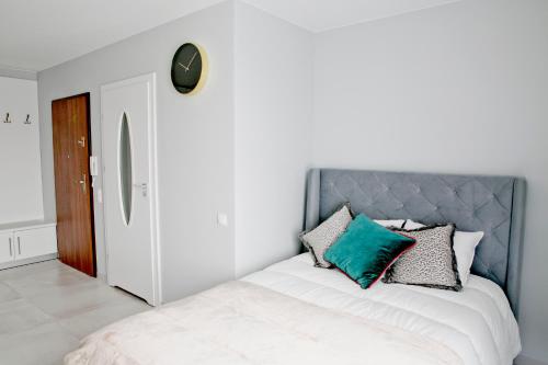 1 dormitorio con 1 cama con cabecero azul en Elegant City Center Apartment 7B, en Cracovia