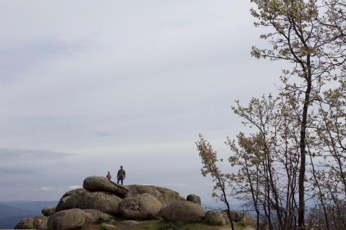 two people standing on top of a pile of rocks at La Grulla Dorada in Perales del Puerto