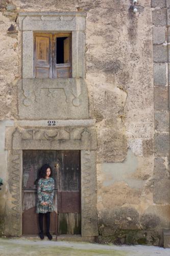 a woman standing in a doorway of a building at La Grulla Dorada in Perales del Puerto