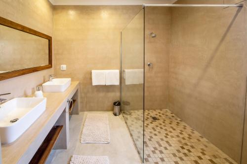 a bathroom with a sink and a shower at Hadassa Guest House in Otjiwarongo